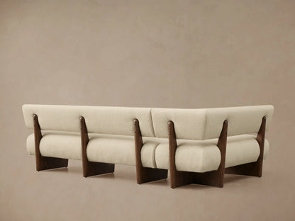 Light cream textured Beau Banquette with a dark oak veneer frame, showing its curved backrest and seat.