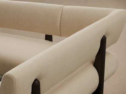Beau Banquette: L-shaped cream upholstered sectional bench with a dark exposed wood frame, on a warm wooden floor.