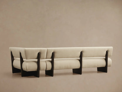 Close-up angled view of a light beige Beau Banquette with dark exposed wood frame details, showing upholstery texture.