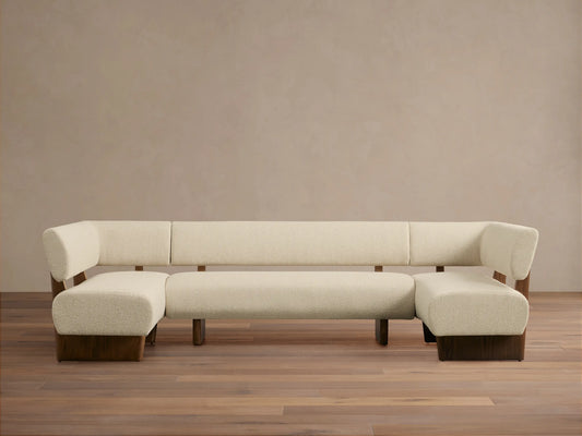 Beau U-Shaped Banquette. Cream textured upholstery, dark wood frame & base. Front view on wood floor.