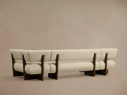 Beau U-Shaped Banquette with light beige textured upholstery and dark wood frame, showing a curved section.