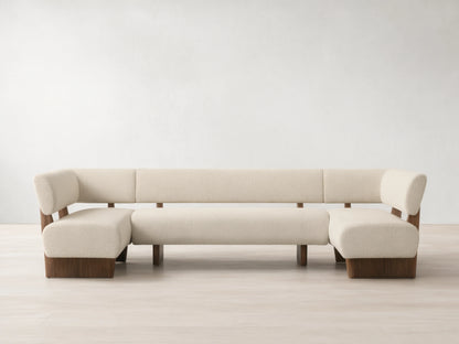 Beau U-Shaped Banquette. Cream textured upholstery, dark wood frame & base. Front view on wood floor.
