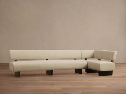 Beau Banquette: modern L-shaped sofa in cream upholstery with a dark wooden exposed frame, on a wooden floor.