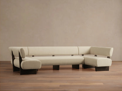 Beau U-Shaped Banquette, cream upholstered seating with dark exposed wood frame, shown straight on in a room.