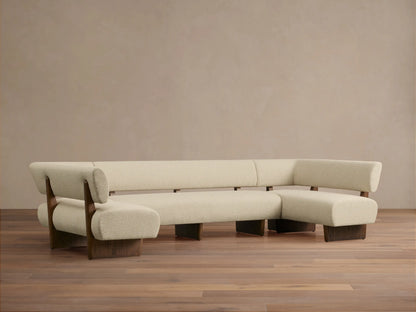 Beau U-Shaped Banquette: Light cream boucle U-shaped sofa with dark wood frame, front view, against a neutral wall.