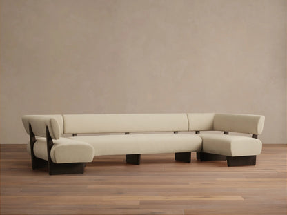 Cream U-shaped banquette with soft cushions, dark exposed wood frame, sitting on a wooden floor.