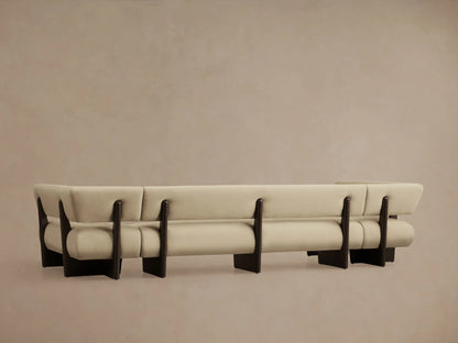 Close-up of Beau Banquette's light beige upholstered back and armrest with visible dark wood frame.