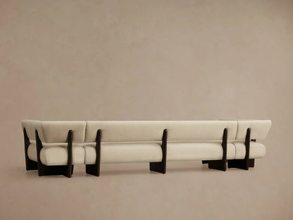 Beau U-Shaped Banquette, close-up of light cream upholstered armrest and backrest with dark brown wood frame.