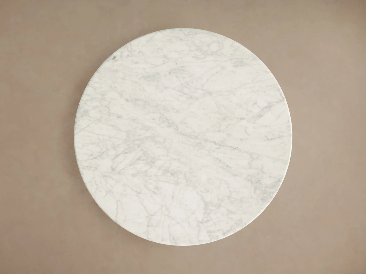 Front view of the Saint Germain Bar Table with a round white veined marble top and a dark steel tulip-shaped base.