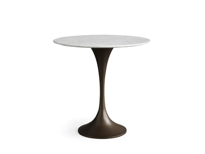 Round Saint Germain Bistro Table with white Carrara marble top, displaying natural gray veining, set against a beige background.
