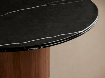 Caden Round Dining Table: black marble top with white veins, glossy finish, on a cylindrical dark walnut wood base.