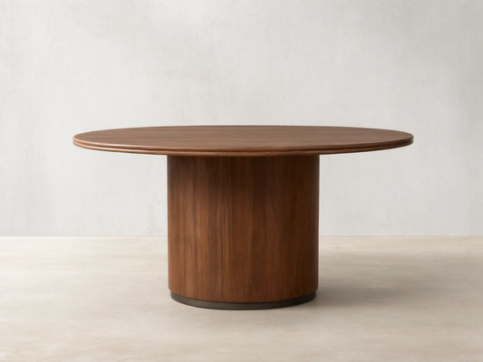 Caden Round Wood Dining Table, dark walnut finish, round top & thick cylindrical base on wood floor.