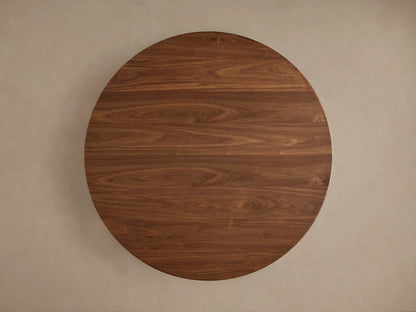 Close-up of Caden Round Wood Dining Table. Dark walnut finish with visible wood grain on round top and cylindrical base.