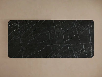 Caden Dining Table with dark walnut wood base and polished black marquina stone top, featuring a subtle sheen finish.