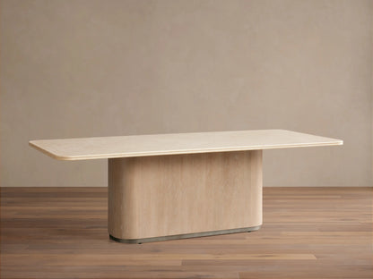 Caden Dining Table featuring a light beige rectangular stone top with rounded corners, on a curved light oak wood base.