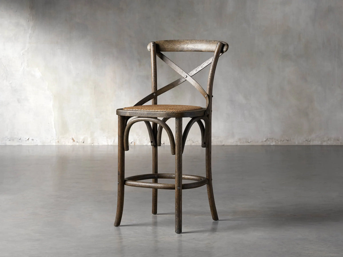 Cadence Stool, natural weathered dark brown oak wood, X-back, curved legs, handwoven natural seagrass rattan seat.