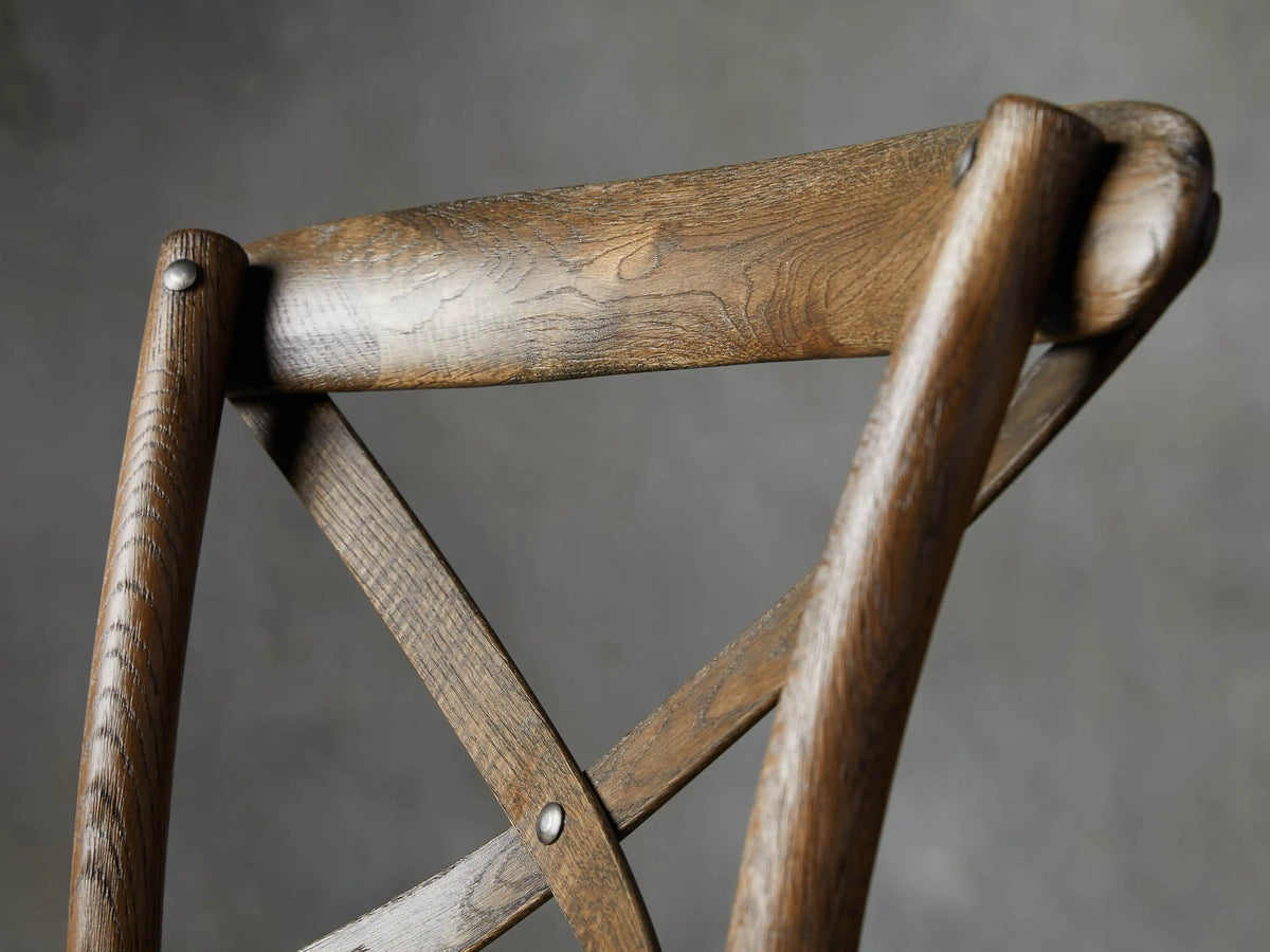 Close-up of Cadence Stool's textured natural sea grass rattan seat and dark weathered oak frame with visible grain.