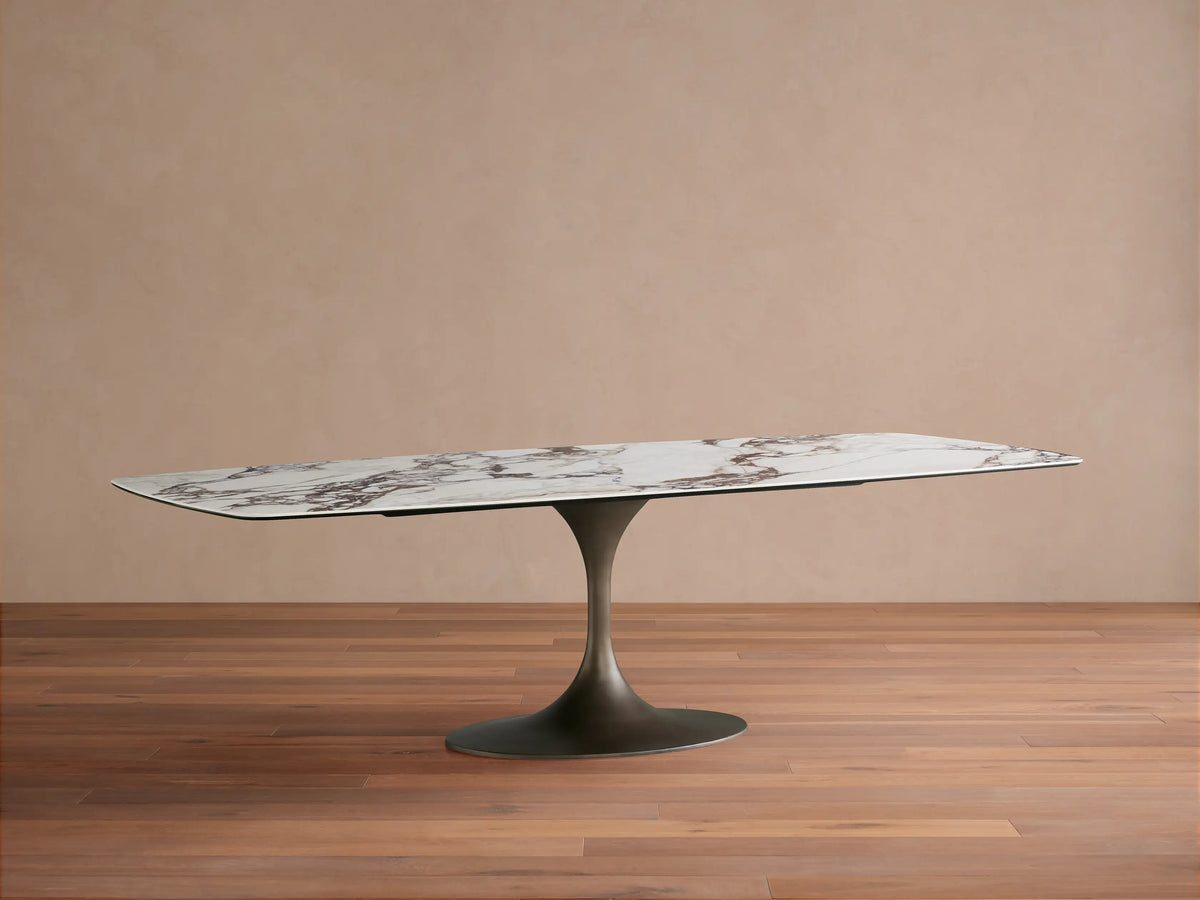 Vincenza Dining Table with Launette Base, featuring a ceramic top with calacatta marble pattern and a sleek steel base.