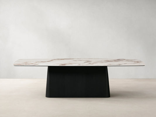 Vincenza Dining Table with calacatta marble-patterned ceramic top and solid wood Toulouse base, set on wooden floor.