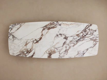 Vincenza Dining Table with a calacatta marble-patterned ceramic top on a thick, rectangular black Toulouse wood base.