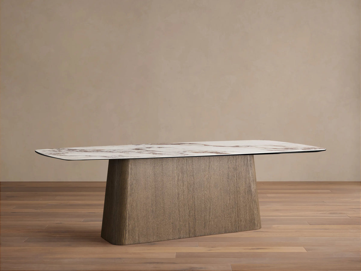Vincenza Dining Table: Rectangular white marble-look top with reddish-brown veins, on a light brown oak veneer base.