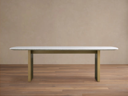 Saint Germain Stone Dining Table with white marble top and olive brown base on wood floor, minimalistic setting.