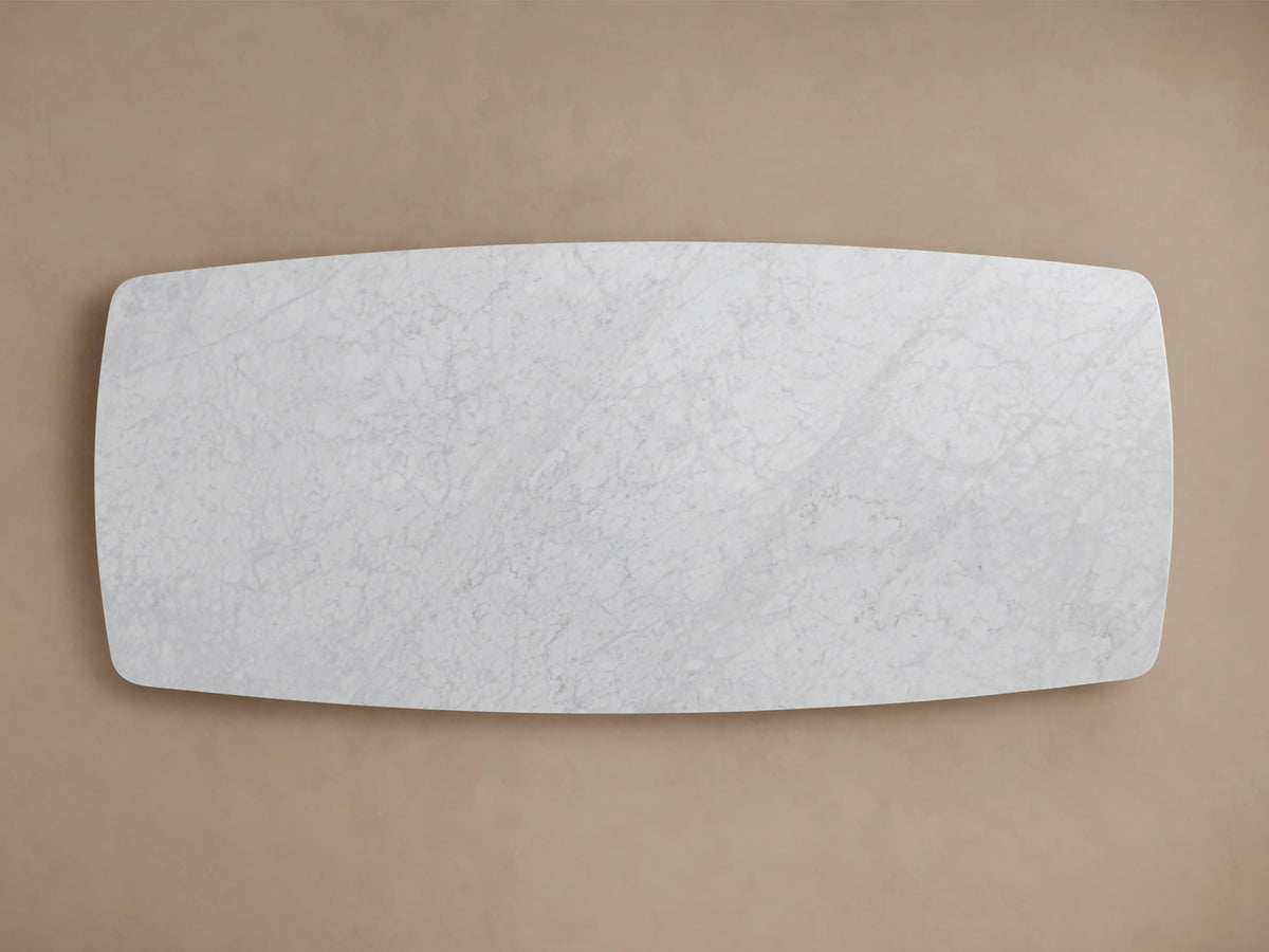 Saint Germain Stone Dining Table features a rectangular Carrara marble tabletop with subtle veining, viewed from above on a beige background.
