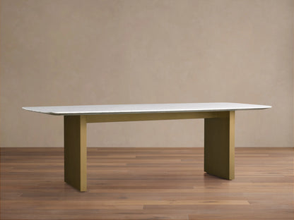 Saint Germain Stone Dining Table with white marble top and olive brown base on wood floor, minimalistic setting.