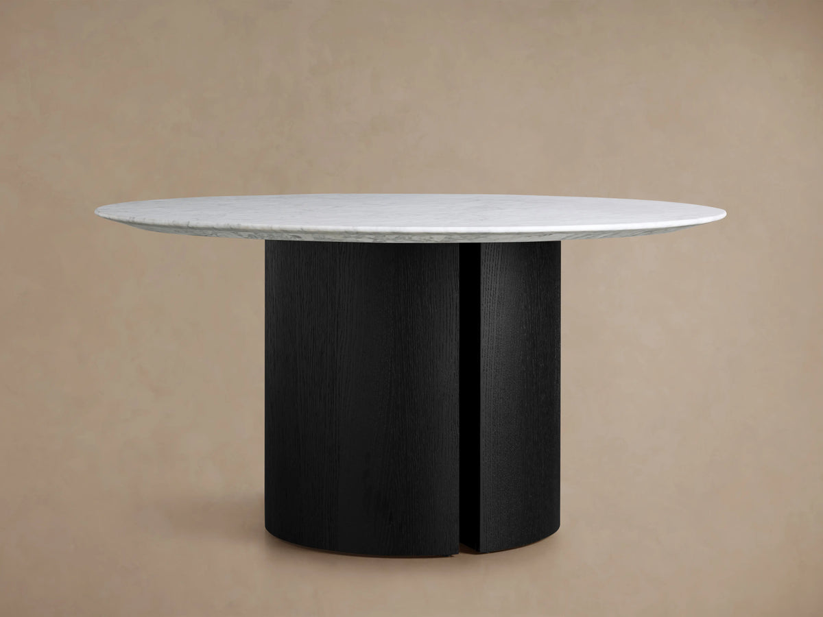 Saint Germain Round Stone Dining Table Carrara marble top, white with intricate grey veining, centered on a neutral beige background.