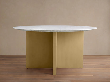 Saint Germain round dining table with a white Carrara marble top and V-shaped antique brass steel base on a wooden floor.