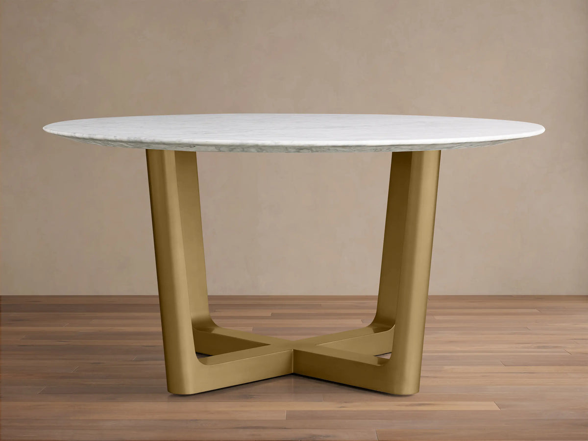 Front view of the White Carrara marble Saint Germain Round Stone Dining Table with Antique Brass Rennes Base in Metal.