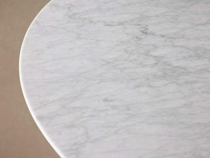 Front view of the White Carrara marble Saint Germain Round Stone Dining Table with Antique Brass Rennes Base in Metal.