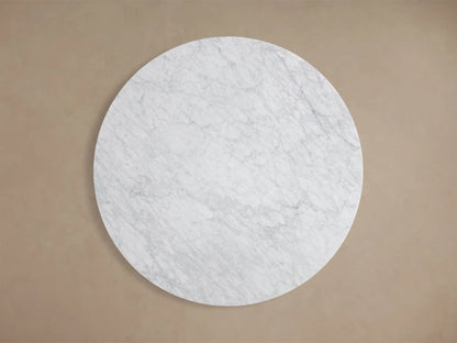 Close-up of the white Carrara marble surface of the Saint Germain Round Stone Dining Table with Rennes Base in Metal, showing grey veining.