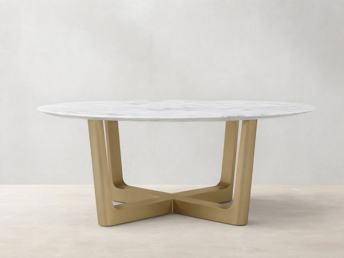 Front view of the White Carrara marble Saint Germain Round Stone Dining Table with Antique Brass Rennes Base in Metal.