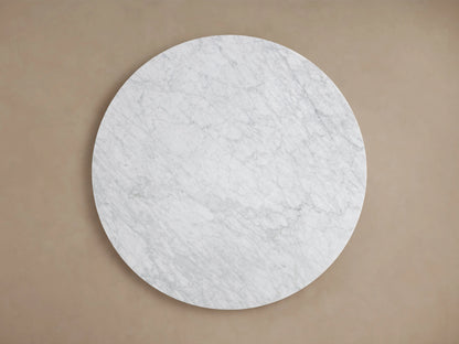 Round tabletop of the Saint Germain Dining Table made from Carrara marble, displaying natural veining and a smooth edge.
