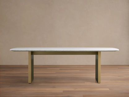 Front view of the Saint Germain 96" Stone Dining Table with Metal Clement Base, white stone top and brass bases.