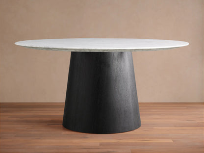 Round dining table with a Carrara marble top in white, featuring subtle veining. The base is a black, cone-shaped structure made of plywood and oak veneers.