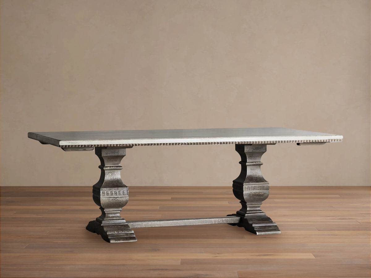 Cerea Amalfi Bell'Arte Dining Table with light gray rectangular top, dark distressed ornate double pedestal bases on wood floor.