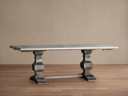 Cerea Amalfi Bell'Arte Dining Table with light gray rectangular top, dark distressed ornate double pedestal bases on wood floor.