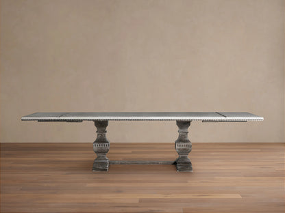 Cerea Amalfi Bell'Arte Dining Table with a distressed light grey rectangular top, hand-painted runner, and two ornate dark pedestal bases.