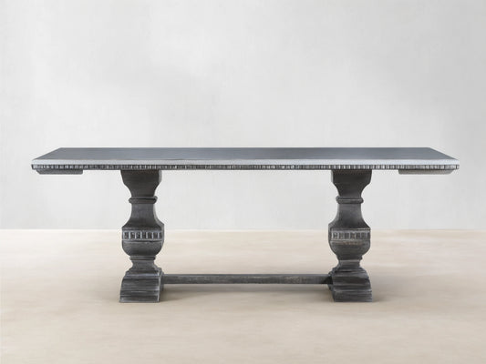 Cerea Amalfi Bell'Arte Dining Table with light gray top, dark distressed pedestal bases, and subtle hand-painted apron detail.