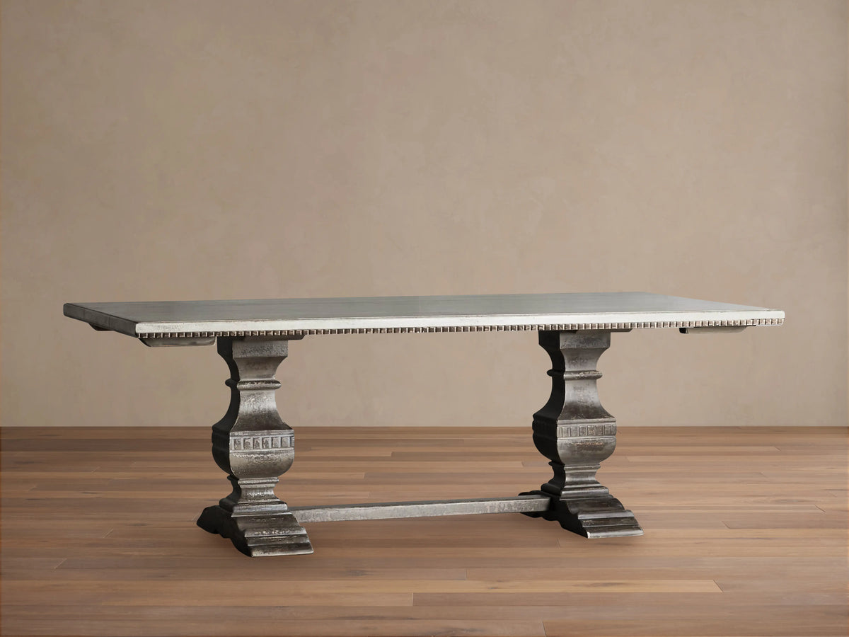 Cerea Amalfi Bell'Arte Dining Table: light gray rectangular top, distressed gray ornate pedestal bases, textured edge.