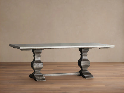 Cerea Amalfi Bell'Arte Dining Table: light gray rectangular top, distressed gray ornate pedestal bases, textured edge.