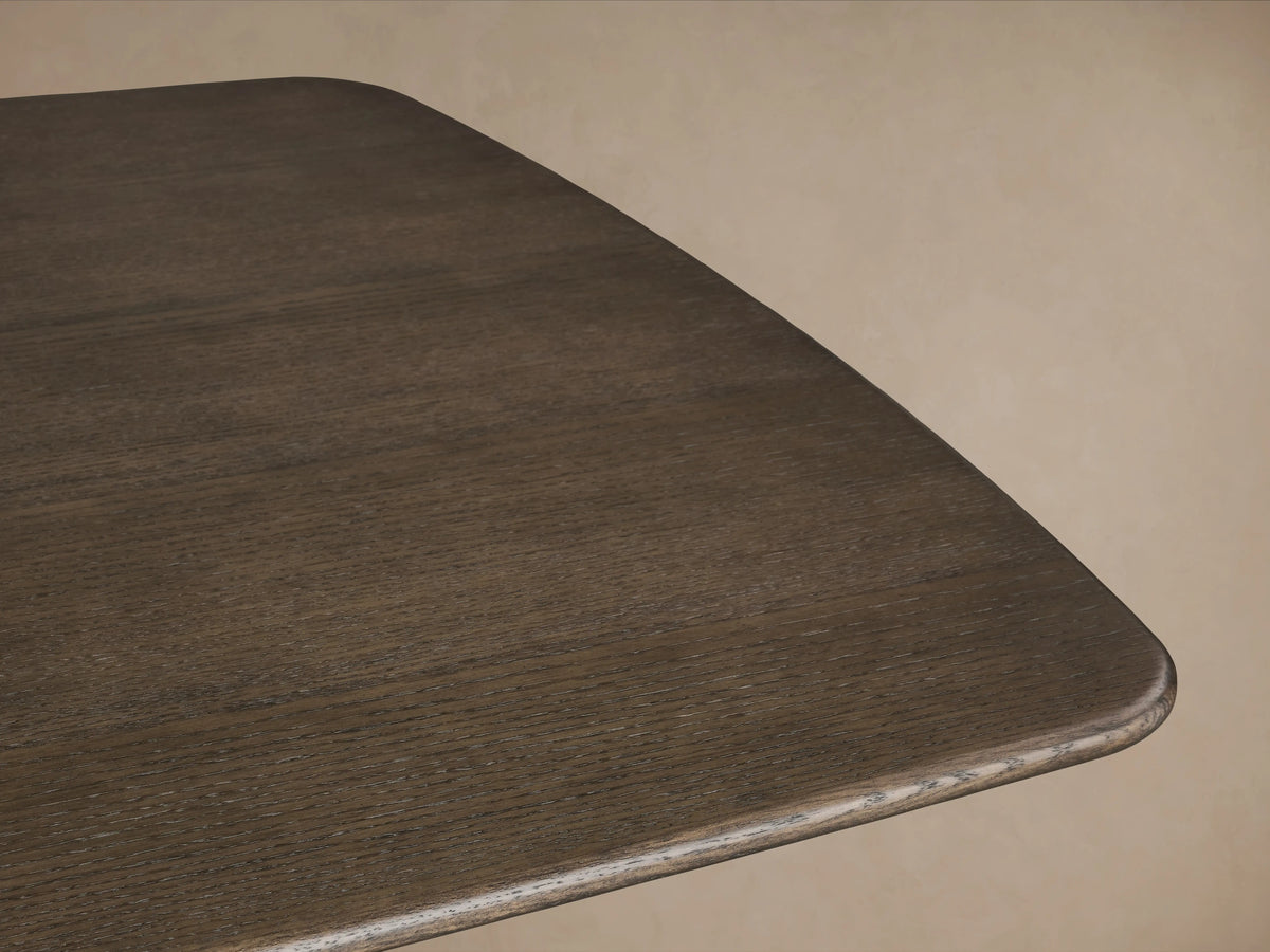 Saint Germain wood dining table with solid oak tabletop, Ebony finish, and two rectangular Dauphine bases on a wooden floor.