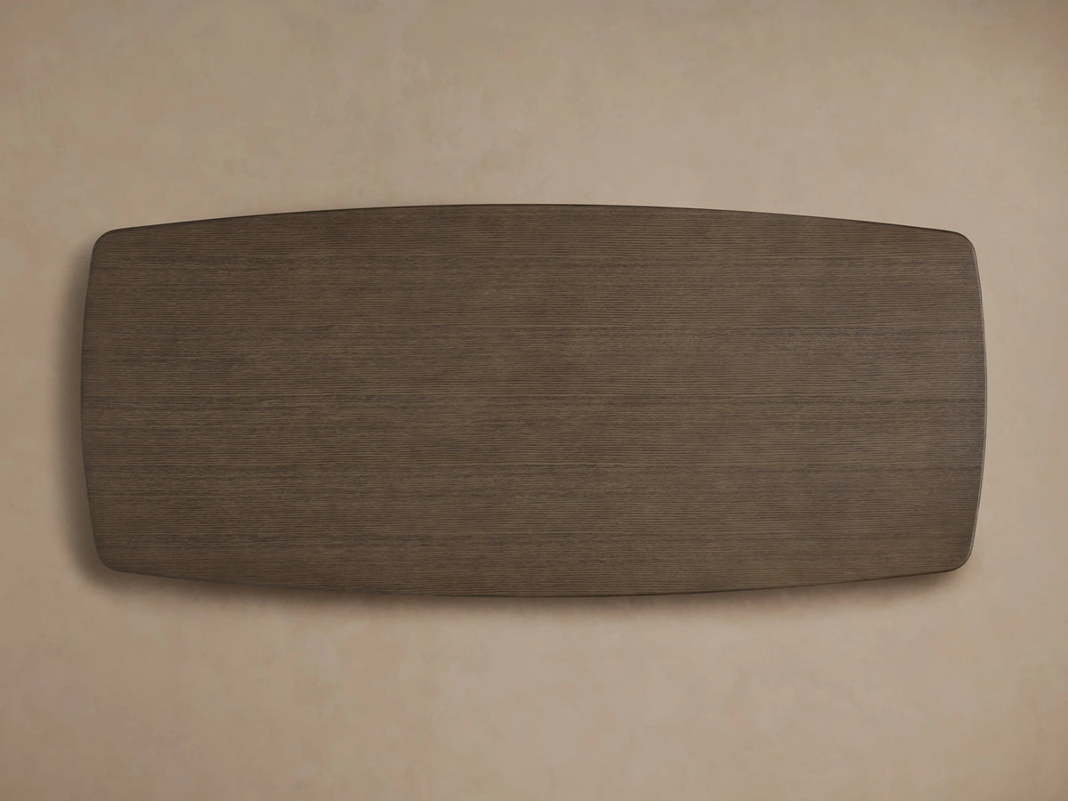 Close-up of an oak dining table corner with a smooth dark Ebony finish, showcasing rounded edges against a neutral background.