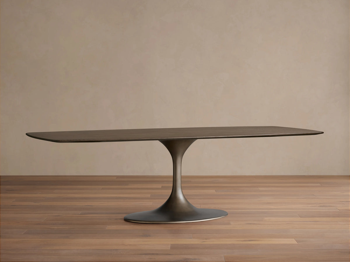 Saint Germain Wood Dining Table with a sleek rectangular oak top, chestnut finish, and steel launette base on wooden floor.