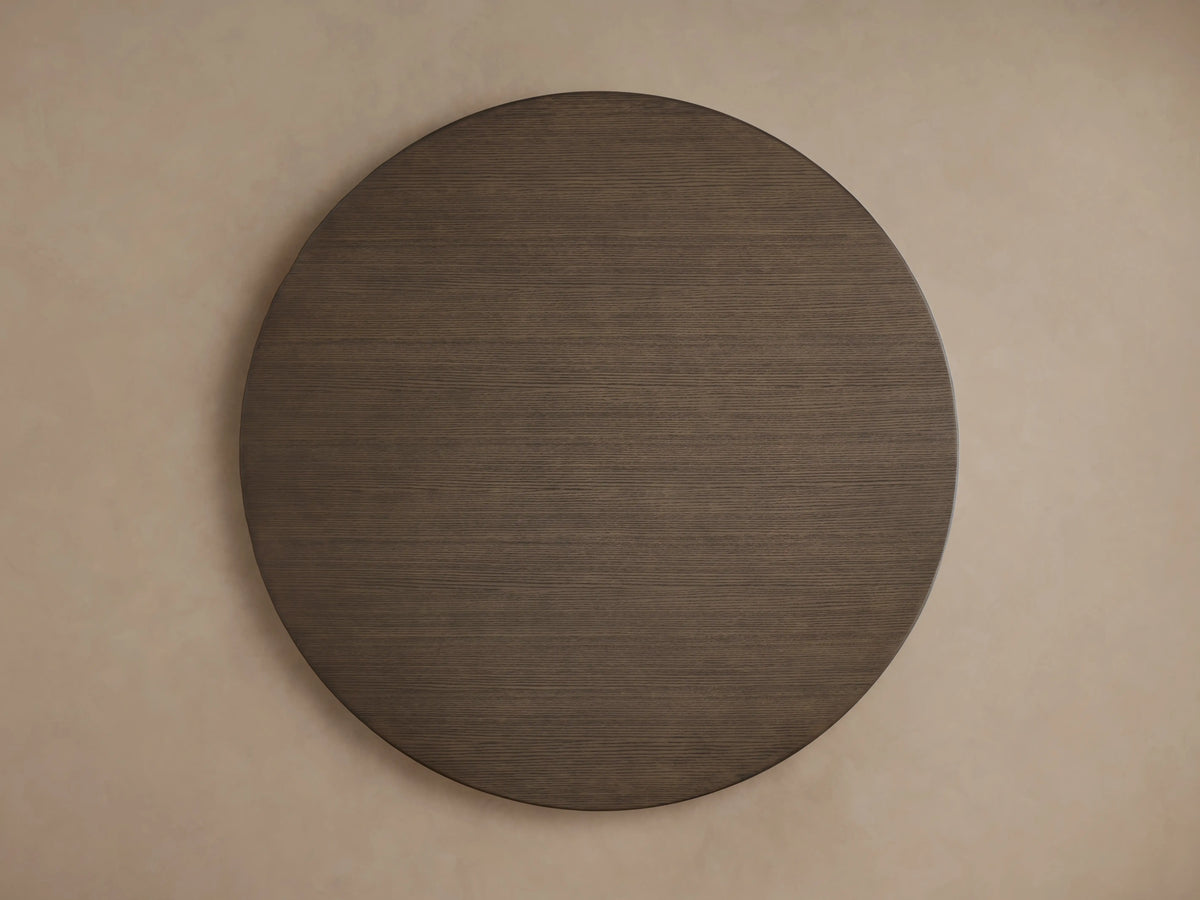 Round wood tabletop of the Saint Germain Dining Table in chestnut finish, displaying detailed oak grain texture.