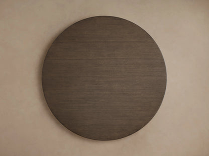 Round wood tabletop of the Saint Germain Dining Table in chestnut finish, displaying detailed oak grain texture.