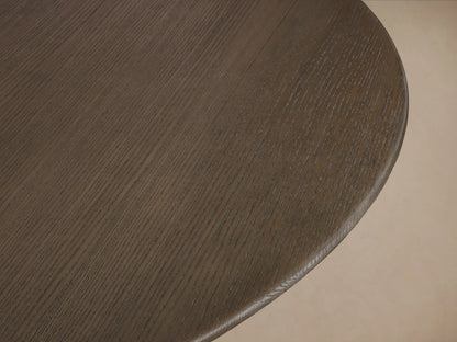 Round wood tabletop with visible oak grain in an ebony finish, showing smooth, slightly beveled edge, on a neutral background.