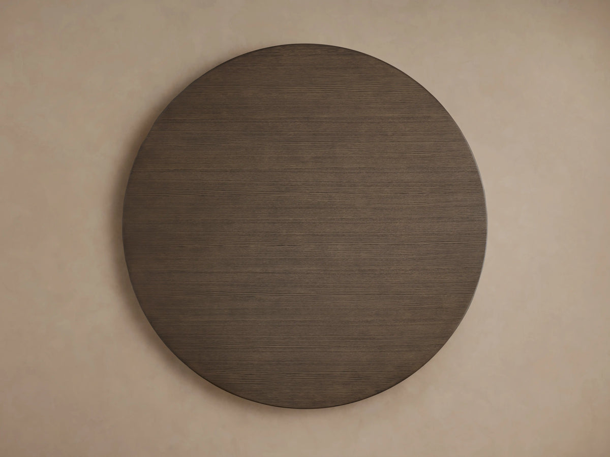 Round wooden tabletop of the Saint Germain Dining Table in a dark chestnut finish, showing wood grain and smooth edge.